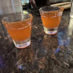 two shot glasses on a counter