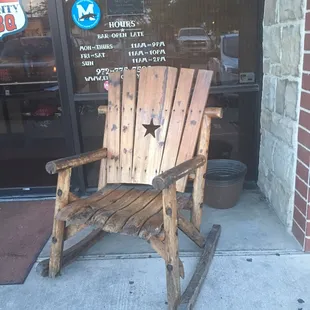 1 o 2 big wooden rocking chairs sitting out front.  Store hours posted on window behind the rocker.