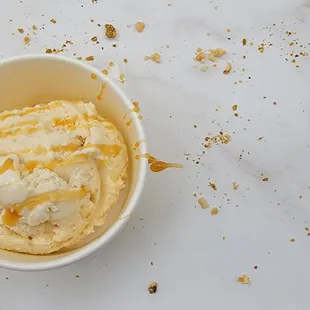 a bowl of ice cream and crumbs