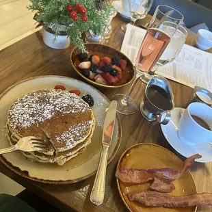Pancakes with a side of bacon and fruit