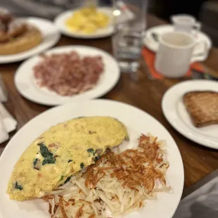 a breakfast of eggs, hash browns, and bacon