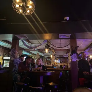 a group of people sitting at a bar