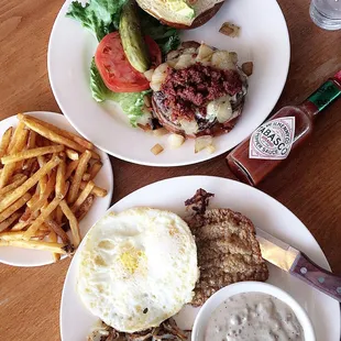 Spanish burger with chorizo and avocado on a pretzel bun. And country fried steak with gravy on the side