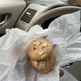 a person holding a cookie in their hand