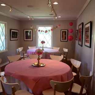 Tables to the left of the front door when you walk in