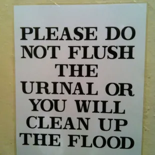 a sign that reads please do not flush the urinal or you will clean up the flood