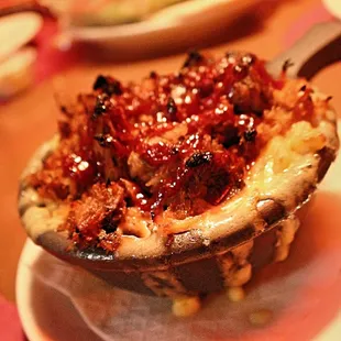 Side of mac and cheese topped with pulled pork real good