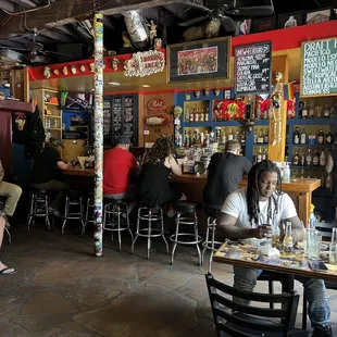 people sitting at tables in a restaurant