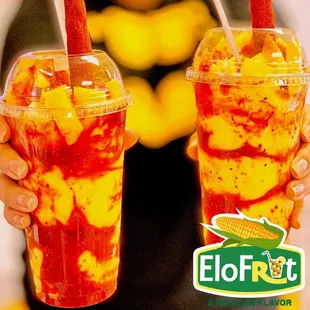 a woman holding two cups of food