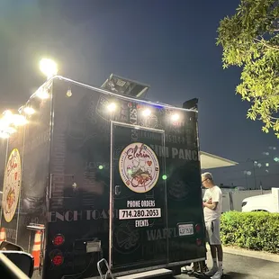 a man standing in front of a food truck