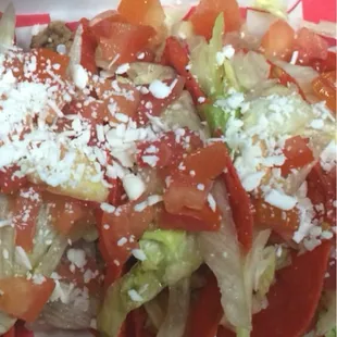 a plate of food with lettuce and tomatoes