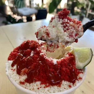 Corn in a bowl with Mayo, cheese, hot sauce and hot Cheetos!