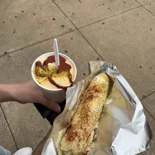  person holding a hot dog and a bowl of ice cream