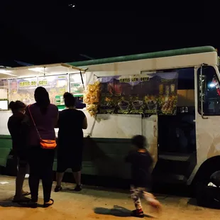people ordering food from a food truck