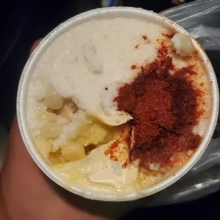 Small elote topped with cheese, butter and chili