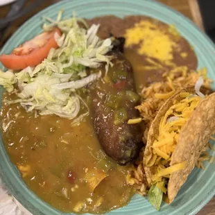 Plate number 1 that has taco beef, Chile relent and with flauta, and beans with rice: