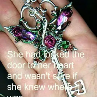 a person's hand holding a key