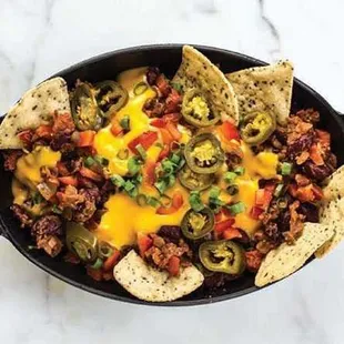 Super Bowl Dish On a large platter, spread out a layer of tortilla chips and one of EL's Famous Chili layered throughout with some