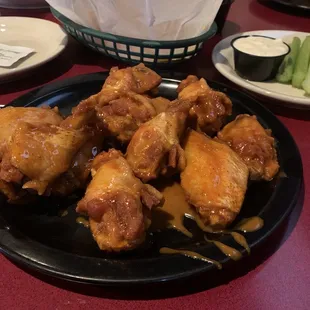 a plate of chicken wings and celery
