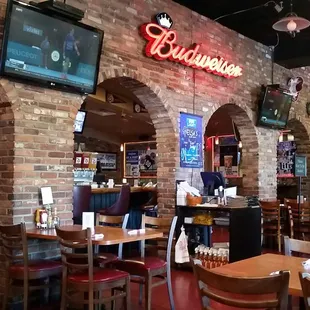 a restaurant with a brick wall