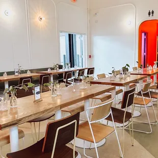 a dining room with a long table and chairs