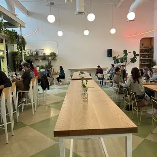 people sitting at tables in a restaurant