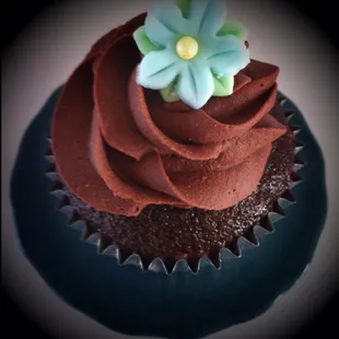 a chocolate cupcake with a flower on top