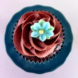 a chocolate cupcake with a flower on top