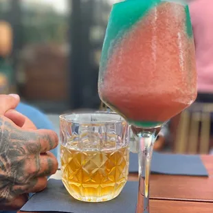 a man holding a glass of watermelon