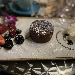 a chocolate dessert with strawberries and powdered sugar