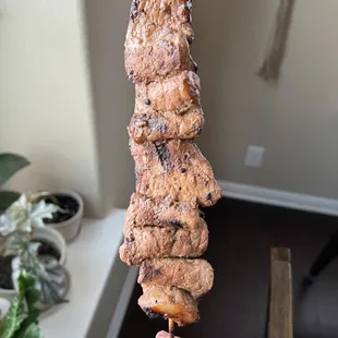 a hand holding a piece of meat