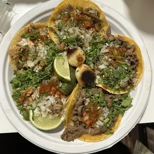 3 carnita taco and 2 carne asada taco buried in my toppings