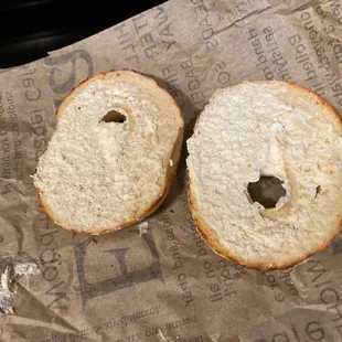 a half eaten bagel with a bite taken out of it