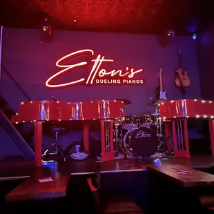 a stage with a neon sign