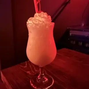 a drink with whipped cream and a straw