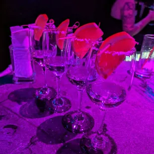a row of wine glasses on a table
