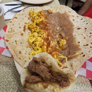 Chorizo, egg, potato, bean, &amp; cheese! On the side, the Carne guisada on a corn tortilla was also ordered and was also amazing!