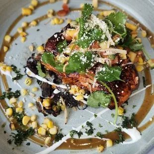 Mole negro glazed king salmon- Blue corn sope, cuitlacoche poblana rajas, jicama, tangy tamarind vinaigrette