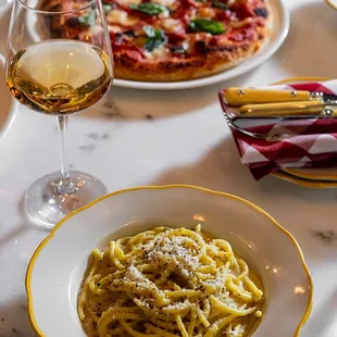 a plate of pasta and a glass of wine