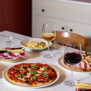 a table with a variety of food and wine