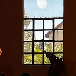 Weird optical illusion makes it look like the Death Star is waiting to blow us up.  Taken from the corner booth in the high ceiling room.