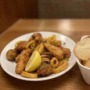 a plate of food and a bowl of chips