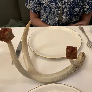 a woman sitting at a table with an antelope on it