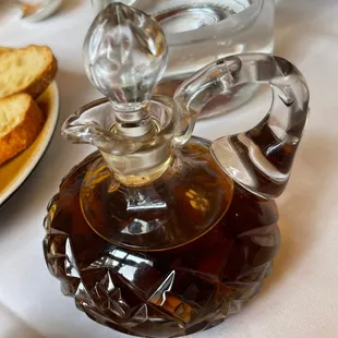 a glass decanter with bread on a plate