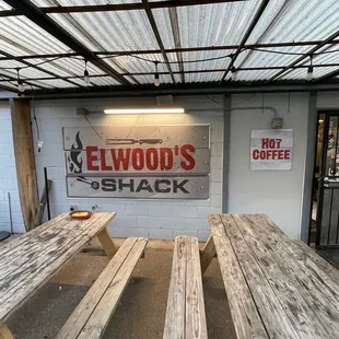 two picnic tables and a soda machine