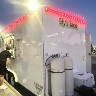 a man standing in front of a food truck