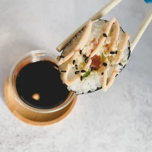 chopsticks holding a sushi