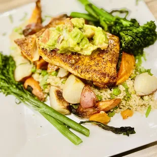 Entree: blackened salmon with roasted potatoes, quinoa, broccolini, and sweet potatoes, topped with avocado salsa.