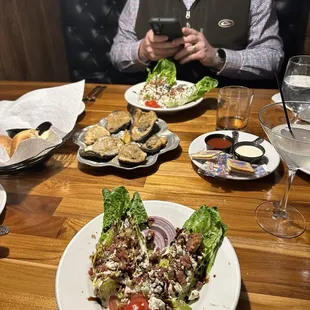 Chargrilled oysters, wedge salad , rolls, lemon martini
