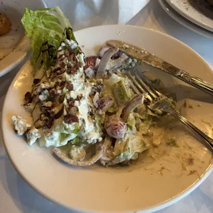Half Wedge salad with blue cheese and bacon and Roma tomatoes with onion - excellent, rich